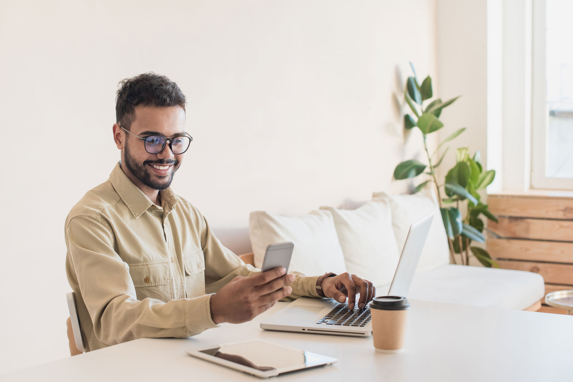 Young-business-owner-using-laptop-working-at-home-online Man Performing Google Search for Colorado Personal Injury Lawyers